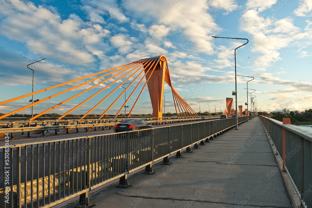 Fototapeta premium cable-stayed bridge in Riga, in the photo south bridge in the evening against the background of blue sky and clouds