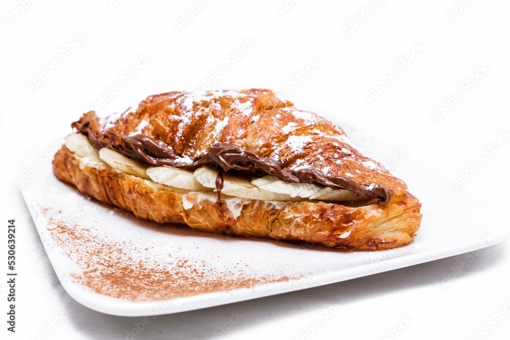 Croissant with chocolate butter and banana isolated on a white background. Croissant with chocolate butter and banana isolated on a white background.