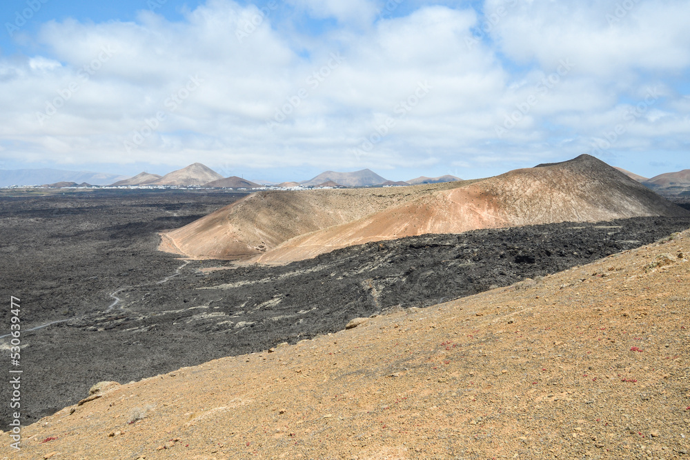 Volcanoes, black lava and islets of Lanzarote seen from Caldera Blanca