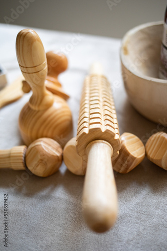 Detail of a wood therapy roller on the massage table.