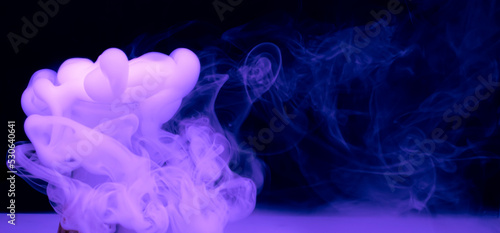 puffs of thick blue smoke against a black background