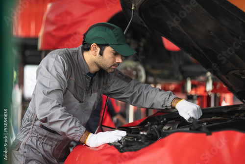 Automobile mechanic man checking car damage broken part condition. diagnostic and repairing vehicle at garage automotive, Concepts of car care check and fixed and services insurance.
