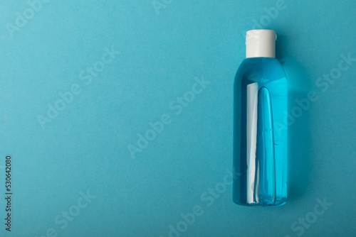 Micellar water . Cleansing the skin of sebum and makeup. Composition on a blue background. Beauty concept. Copy space text. flat lay
