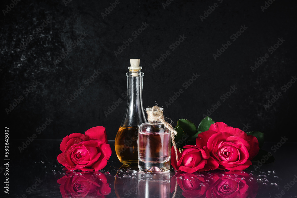 Bottles of perfume and red roses. Bottles of perfume and red roses.