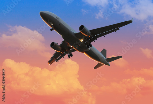 airplane in beautiful colorful dramatic sky with cloud, handsome sunset, Dawn, concept flight in heavenly space, meditative calmness, international transportation, cargo transportation