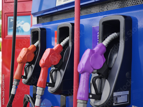 gas pump nozzles. fuel dispenser. The purple fuel nozzles are arranged in several colors. Gasoline and diesel service stations. The purple fuel dispenser is installed in the blue oil dispenser. 