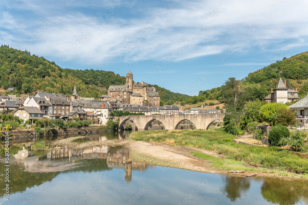 Medieval bridge over Lot with castle in village of Estaing.