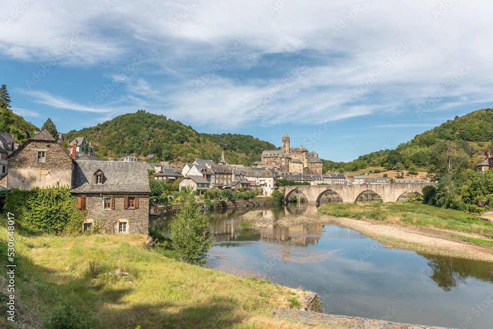 Medieval bridge over Lot with castle in village of Estaing.
