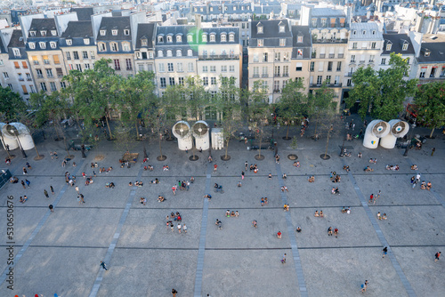 People resting on a concrete square at the Centre Pompidou in Paris