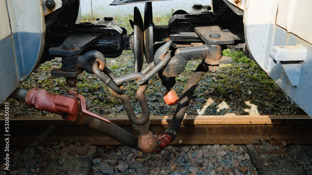 Close-up detail of iron connection of two train wagons. Railway car coupler and train buffers. Buffers and chain coupler. Kyiv Children's Railway in Syretsky Park Close-up detail of iron connection of two train wagons. Railway car coupler and train buffers. Buffers and chain coupler. Kyiv Children's Railway in Syretsky Park