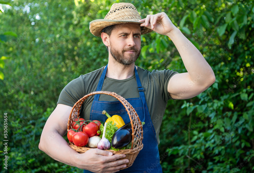 horticulturist in straw hat hold basket full of vegetables
