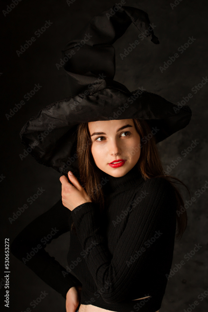 beautiful young woman in a witch's hat beautiful young woman in a witch's hat