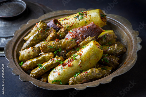 Traditional Turkish cuisine; Mixed Stuffed Vegetables. Stuffed leaves, stuffed zucchini and stuffed eggplant. Turkish name; Yaprak sarmasi, kabak dolmasi photo