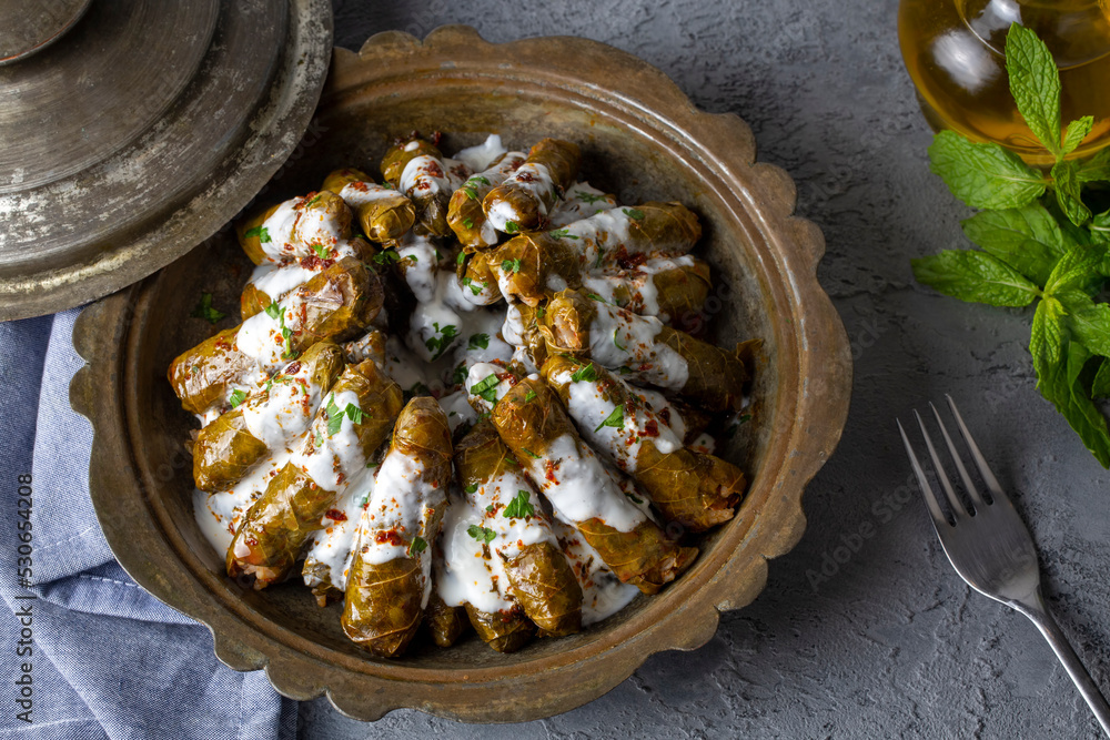 Delicious dolma (sarma) stuffed grape leaves rice, white yogurt sauce ...