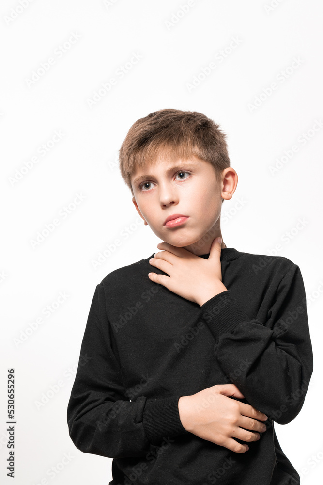 The child has a sore throat, the child is holding his throat with his