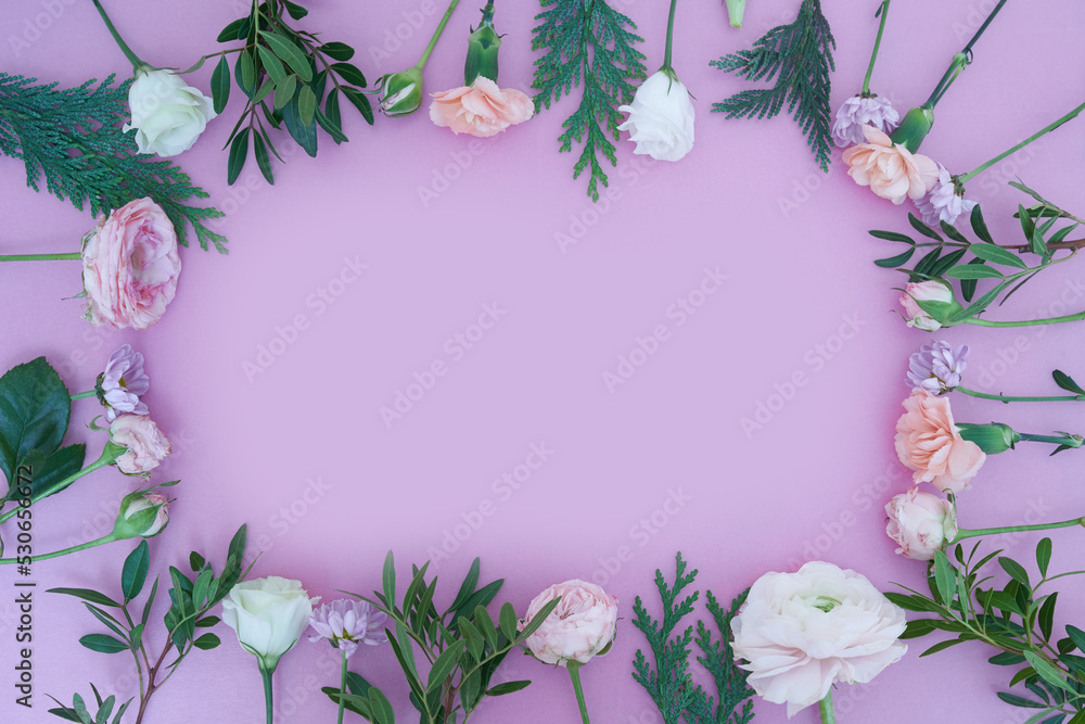 View from above. Close-up of a frame of fresh flowers rose, ranunculus, carnation, juniper, eustoma, bush chrysanthemum, on a lilac background. With a space to copy. High quality photo View from above. Close-up of a frame of fresh flowers rose, ranunculus, carnation, juniper, eustoma, bush chrysanthemum, on a lilac background. With a space to copy. High quality photo