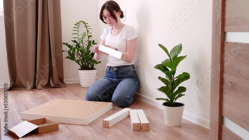 Woman tries to assemble a coffee table, but can't figure out how to do it