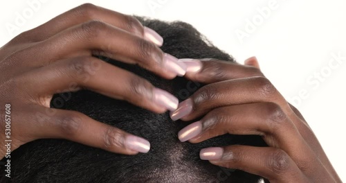 Close up of an African woman's head. She is vigorously scratching her scalp. Isolated on a white background.