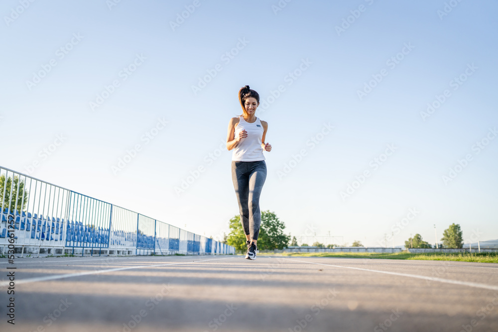 one woman run on stadium running track training