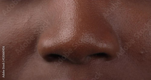Close up view of a black woman nose. Wrinkling nose on smelly odor.
