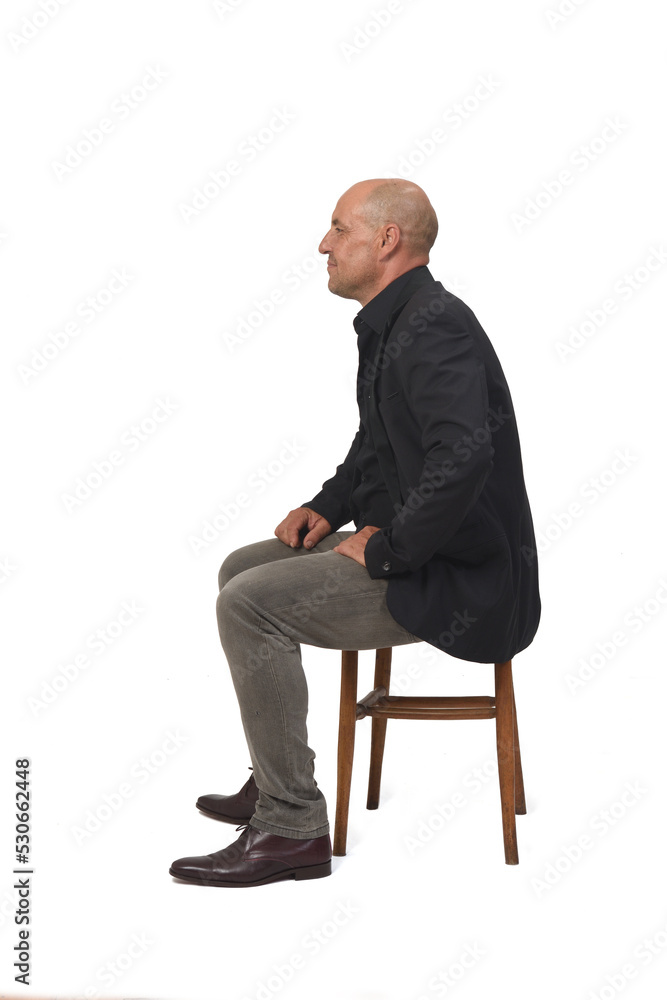 side view of a man sitting on chair with on white background side view of a man sitting on chair with on white background