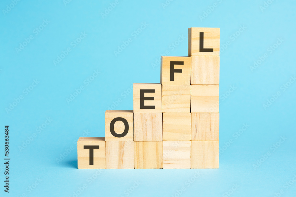the word toefl is written on a wooden cubes, concept the word toefl is written on a wooden cubes, concept