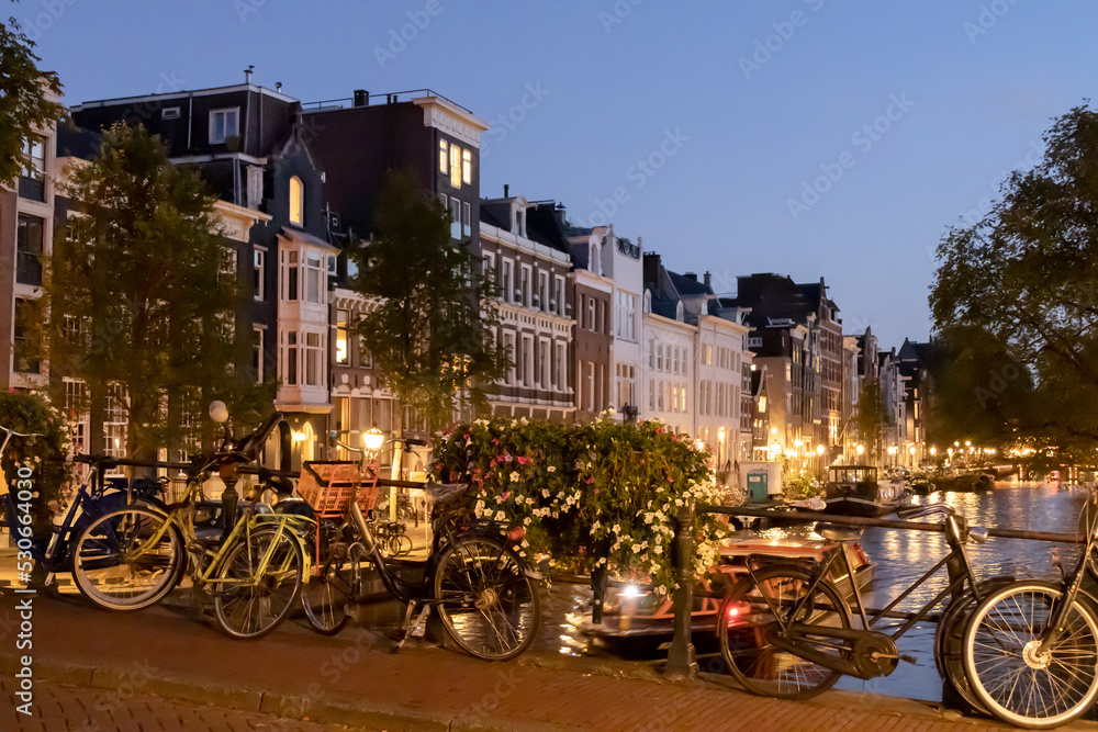 Typical old Amsterdam houses and chanels. Medieval houses at the Amstel in Amsterdam the Netherlands at night