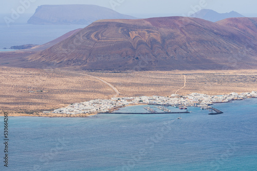 Port of Caleta de Sebo (main settlement and capital community of island) on La Graciosa Island from Mirador de Guinate. Lanzarote. Canary Islands. Spain.