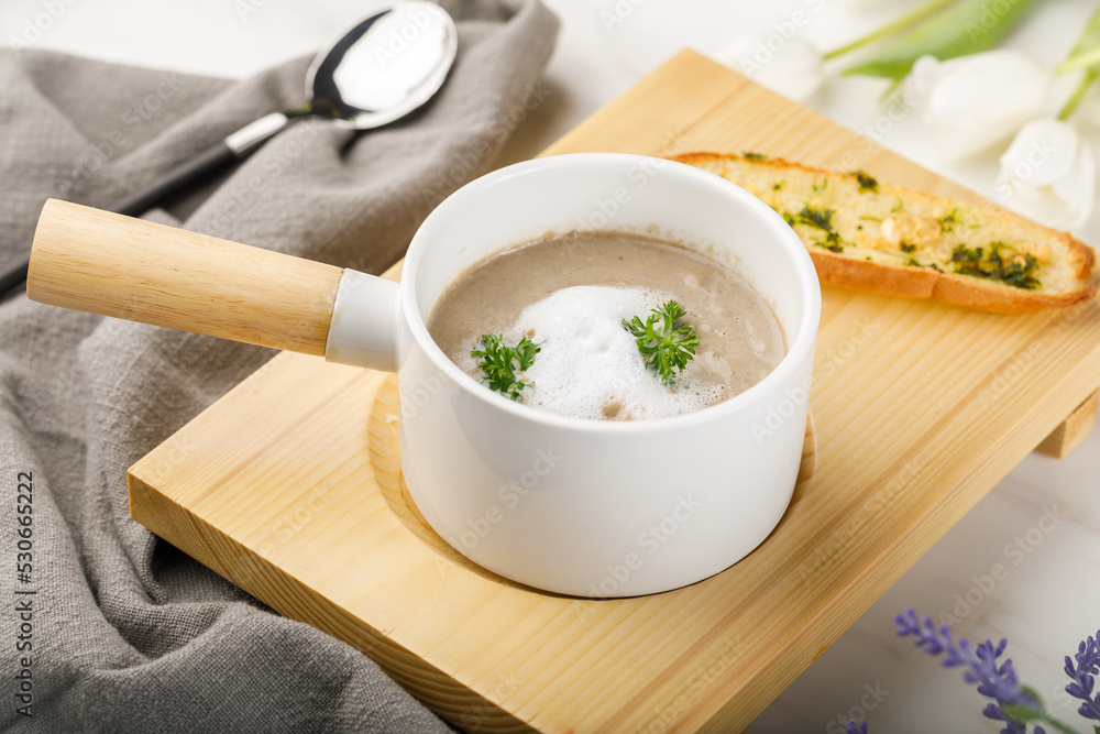 Ideal mushroom sup with garlic bread served in a dish isolated on table side view of arabian soup Ideal mushroom sup with garlic bread served in a dish isolated on table side view of arabian soup