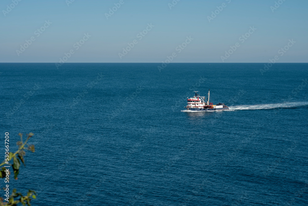 Amasra city, fishing boat at water with blue sky and sea Amasra city, fishing boat at water with blue sky and sea