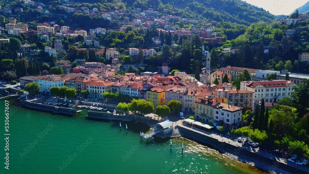 Aerial view of Lake Como. city center. A local ferry arrives in the city. Bell tower. Tourism and romance. Mountains around the lake. Red roofs. Green Planet. Sailing yacht. Italy, Bellano, 09.2022 Aerial view of Lake Como. city center. A local ferry arrives in the city. Bell tower. Tourism and romance. Mountains around the lake. Red roofs. Green Planet. Sailing yacht. Italy, Bellano, 09.2022