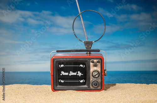 Old red television on the beach