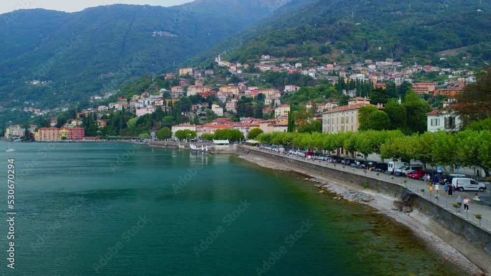 Aerial view of Lake Como. city center. A local ferry arrives in the city. Bell tower. Tourism and romance. Mountains around the lake. Red roofs. Green Planet. Sailing yacht. Italy, Bellano, 09.2022 Aerial view of Lake Como. city center. A local ferry arrives in the city. Bell tower. Tourism and romance. Mountains around the lake. Red roofs. Green Planet. Sailing yacht. Italy, Bellano, 09.2022