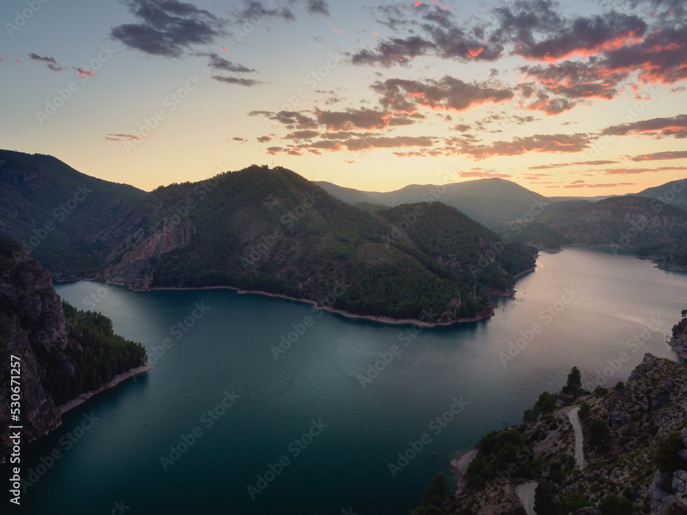 A lake at sunset with mountains and nice colored clouds