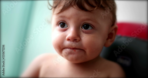 Adorable baby infant child face in highchair