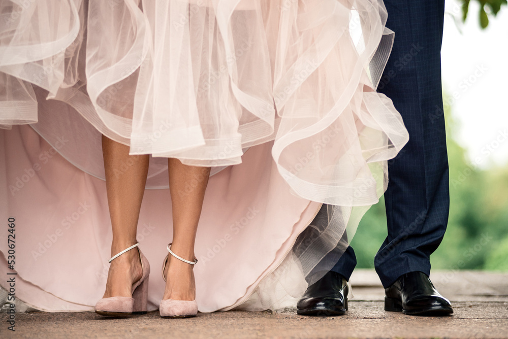 beautiful legs of a girl in shoes stand next to the legs of a man in trousers beautiful legs of a girl in shoes stand next to the legs of a man in trousers