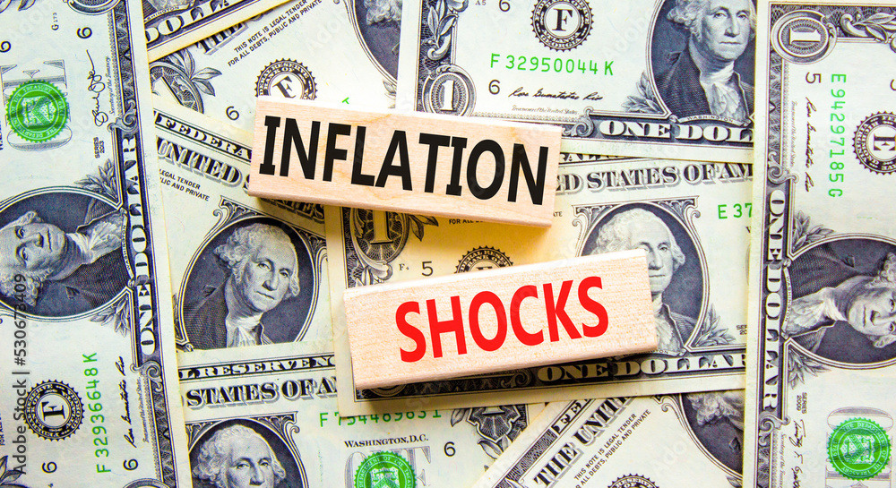 Inflation shocks symbol. Concept words Inflation shocks on wooden blocks. Beautiful background from dollar bills. Business inflation shocks concept. Copy space.