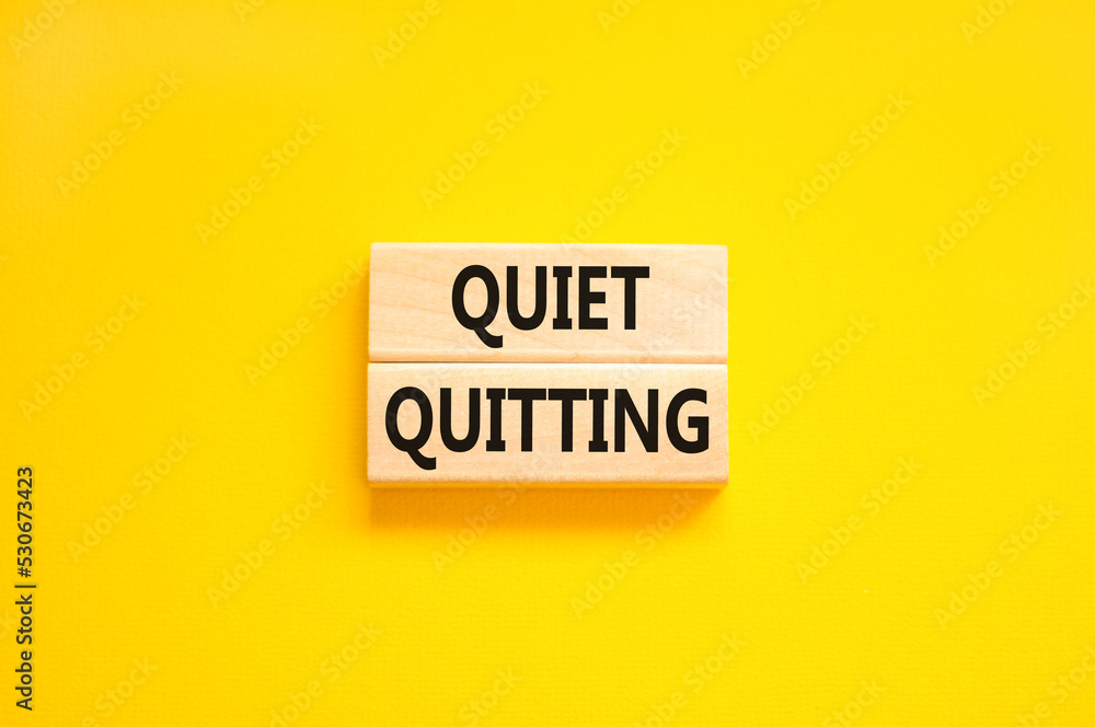 Quiet quitting symbol. Concept words Quiet quitting on wooden blocks. Beautiful yellow table yellow background. Business and quiet quitting concept. Copy space. - obrazy, fototapety, plakaty 