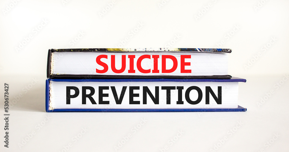 Suicide prevention symbol. Concept words Suicide prevention on books. Beautiful white table white background. Psychological and suicide prevention concept. Copy space.