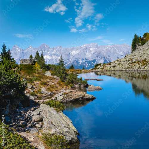 Calm autumn Alps mountain lake with clear transparent water and reflections. Spiegelsee or Mittersee or Mirror Lake  Reiteralm  Steiermark  Austria.