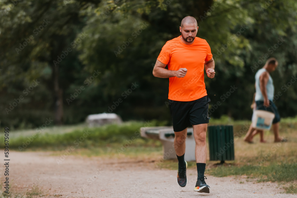 Athletic young man running in nature. Healthy lifestyle