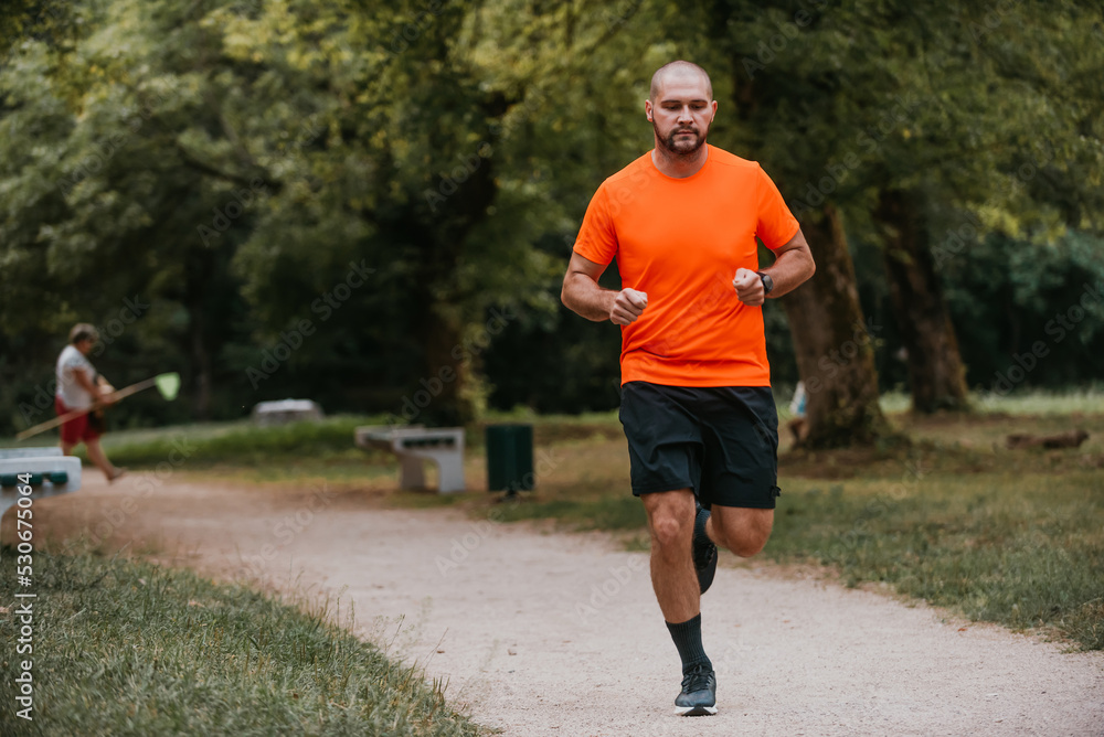 Athletic young man running in nature. Healthy lifestyle Athletic young man running in nature. Healthy lifestyle