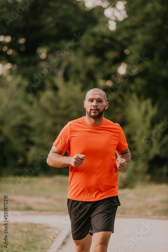 Athletic young man running in nature. Healthy lifestyle