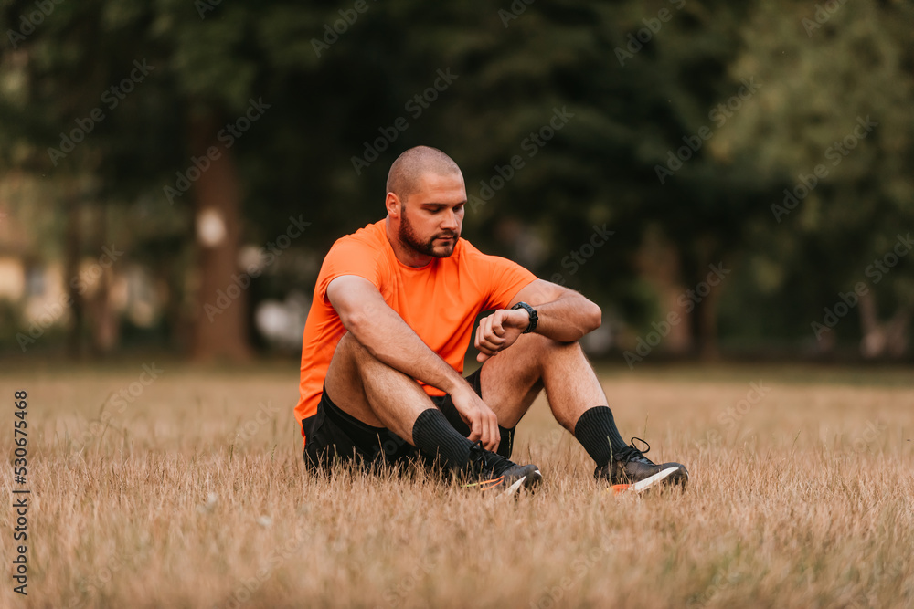 Fototapeta premium Athlete resting after a strenuous morning run