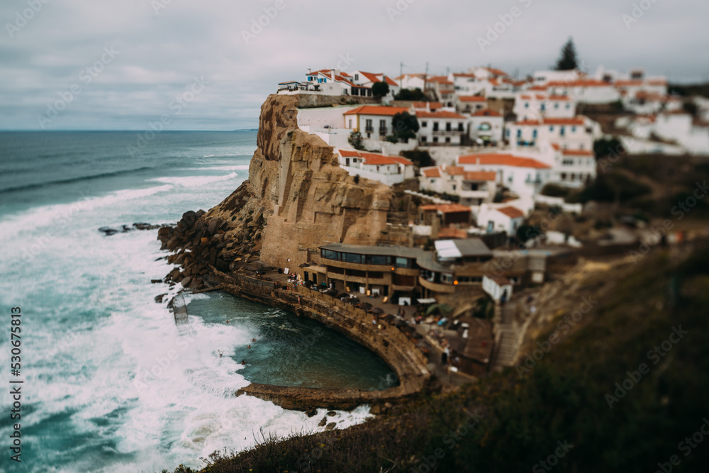 View to Azenhas do Mar rocky beach and village in Colares, Portugal. Tilt-shift effect