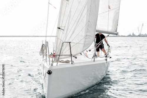 Front close-up view of a sailing yacht during regatta