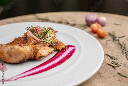 Fototapeta Naklejka Na Ścianę i Meble -  Different cuts of meat, chicken and pork on a white plate on a light wooden background
