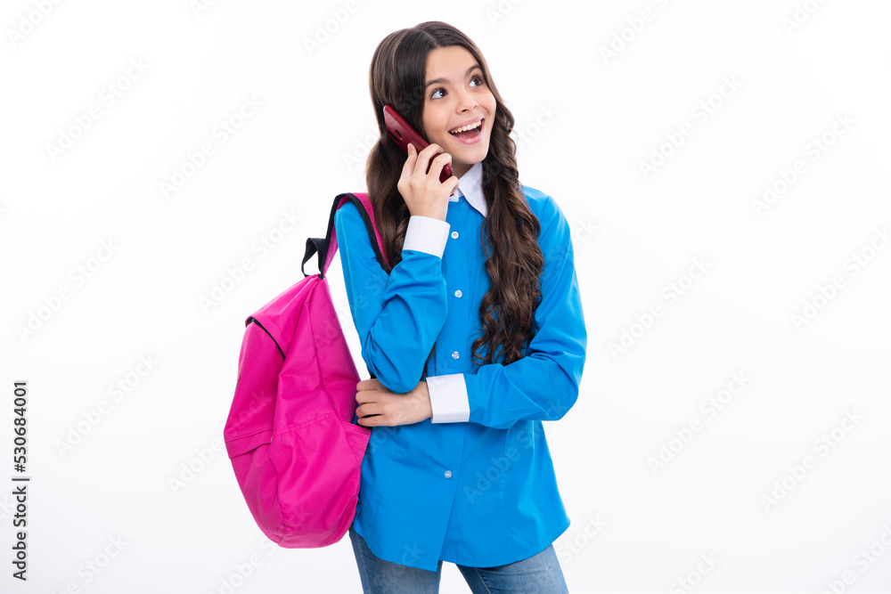 Teen school student girl hold backpack use mobile cell phone on white background. Surprised emotions of young teenager girl. Teen school student girl hold backpack use mobile cell phone on white background. Surprised emotions of young teenager girl.