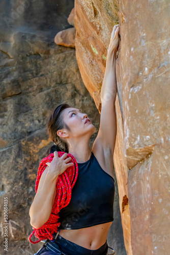 A Fit Mixed Race Female Athlete Rock Climbs In The Pacific Northwest
