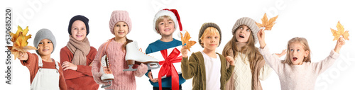 Group of little children in autumn and winter clothes on white background